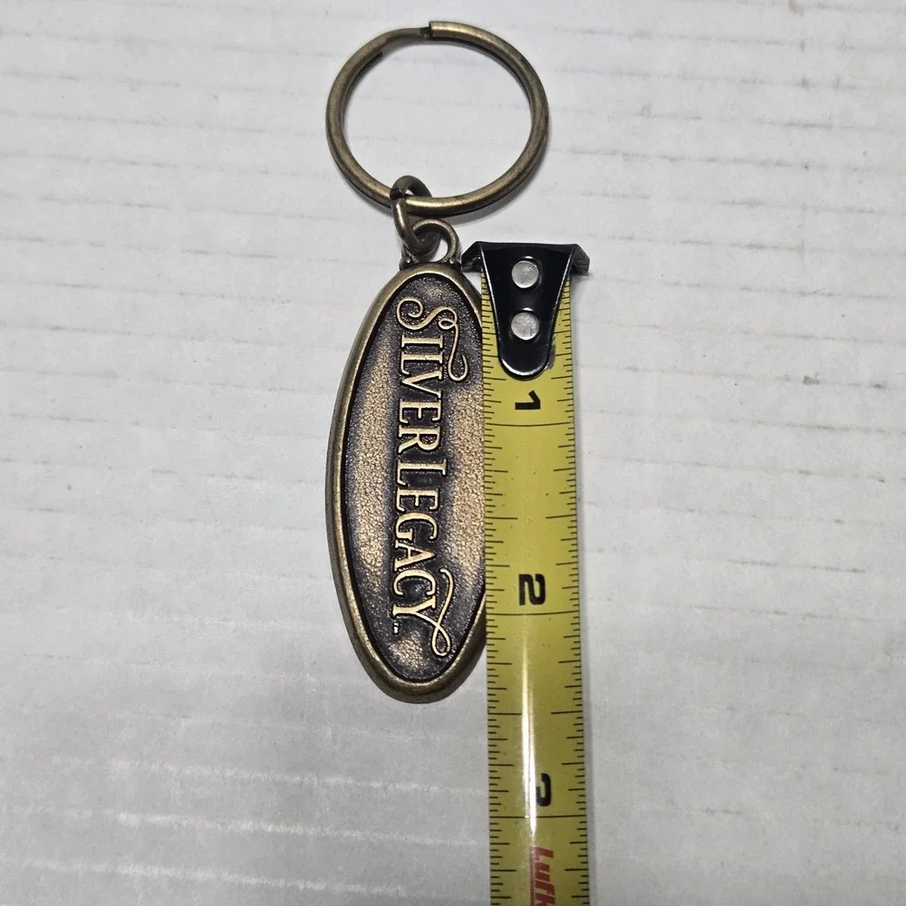 Vintage Silver Legacy Resort Casino Reno Nevada Brass Oval Souvenir Keychain Tag